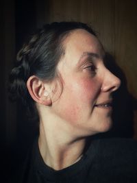 Close-up portrait of young woman looking away