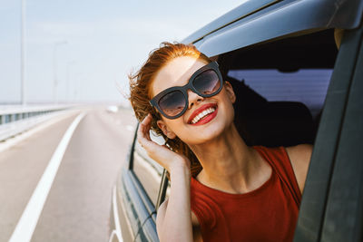 Portrait of young woman in car