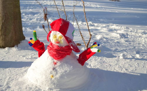 A snowman with a red scarf