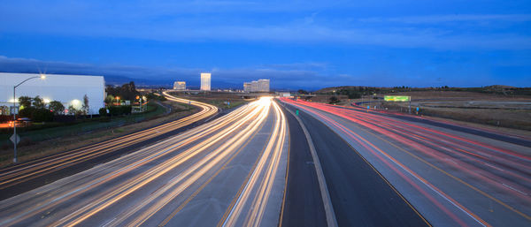 High angle view of light trails on road at night