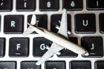 Close-up of toy airplane on laptop keyboard