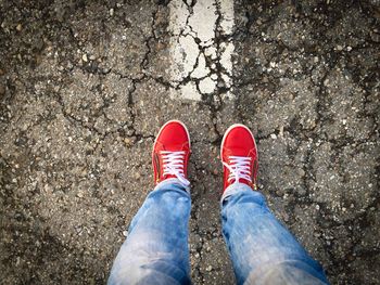 Low section of man standing on road