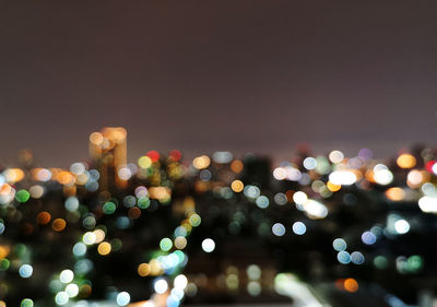 Defocused image of illuminated city at night