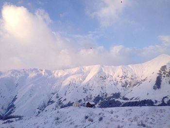 Scenic view of snow covered mountains against sky