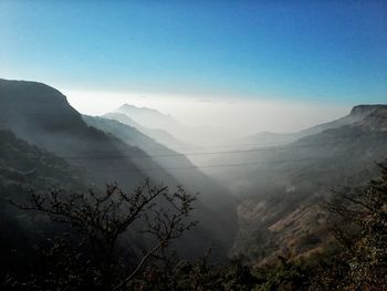 Scenic view of mountains against blue sky