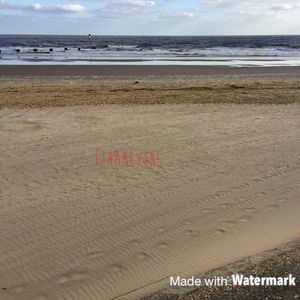 Text on sand at beach against sky