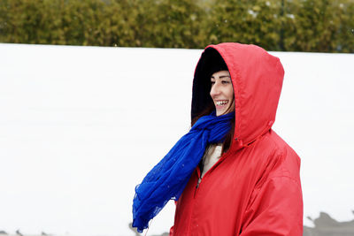 Woman with red umbrella standing in winter