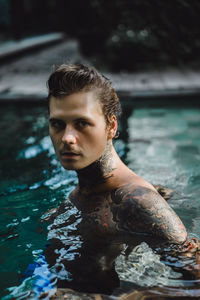 Portrait of young man in swimming pool