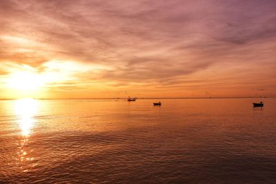 Scenic view of sea against orange sky