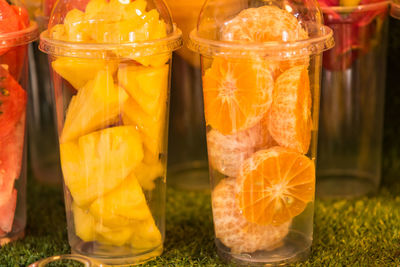 Close-up of orange fruits in glass container