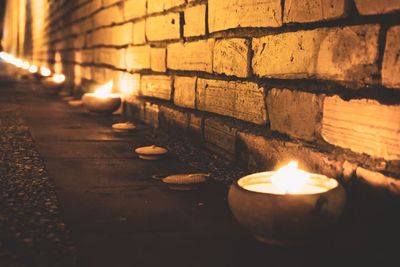 Close-up of lit candles in temple