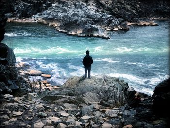 Rear view of man looking at sea