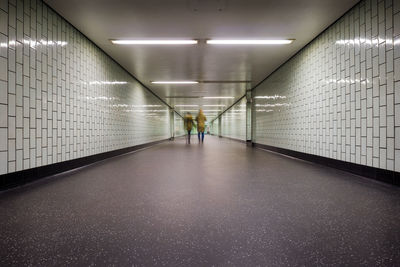 Man walking in illuminated corridor