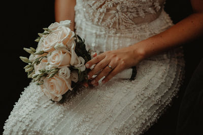 Midsection of woman holding flower bouquet