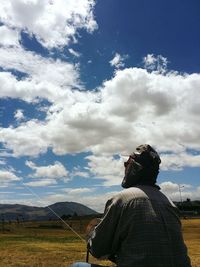 Rear view of man standing on mountain