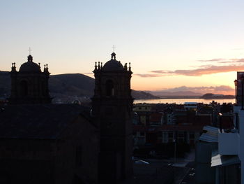 View of buildings in town at sunset