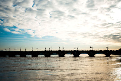 Mid distance view of silhouette pont de pierre over garonne river