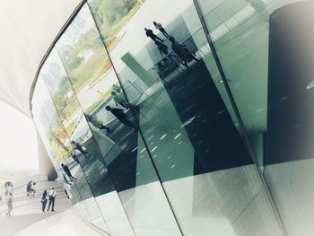 High angle view of modern glass building in city