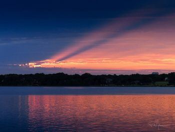 Scenic view of lake against romantic sky at sunset