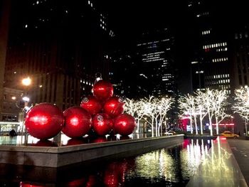 Close-up of christmas decorations in city at night