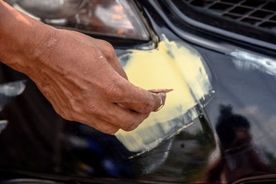 Close-up of man working on car