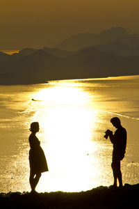 Full length of a silhouette couple on beach