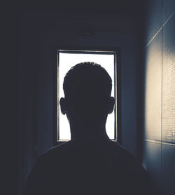 Rear view of silhouette man at home