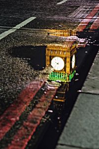 Illuminated railroad tracks at night