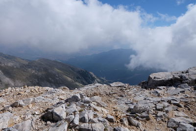 Low angle view of rocks against mountain range