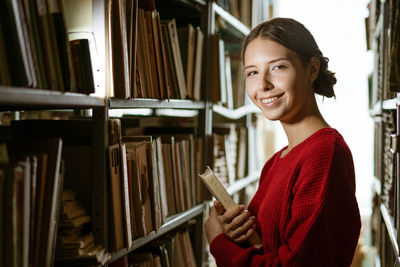 Portrait of young woman reading book