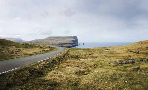 Road by sea against sky