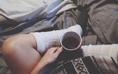 Midsection of woman holding coffee cup