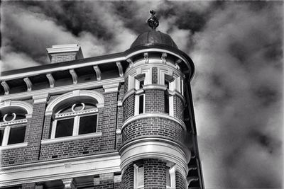 Low angle view of building against cloudy sky