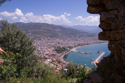 High angle view of bay and cityscape against sky