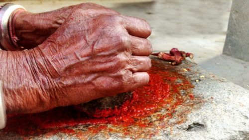 Close-up of hand making chili paste