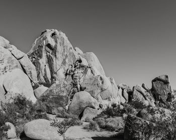 Rock formations on landscape against clear sky