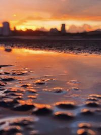 Scenic view of sea against dramatic sky during sunset