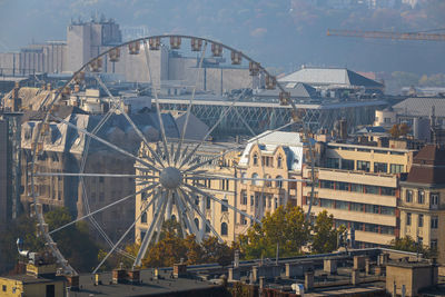 Ferris wheel in city against sky