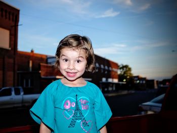 Portrait of happy man standing in front of blue sky