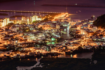 High angle view of illuminated city buildings at night