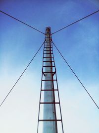 Low angle view of cables against blue sky