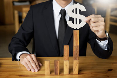 Midsection of man working on wood