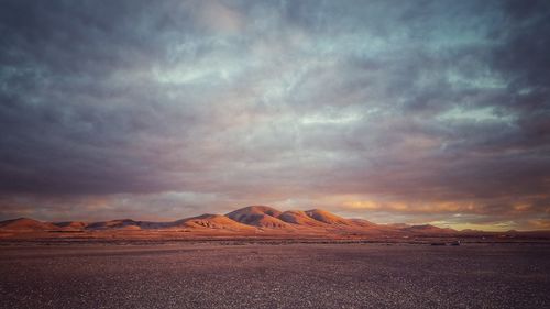 Scenic view of dramatic sky over desert