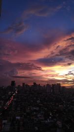 High angle view of illuminated buildings against sky during sunset