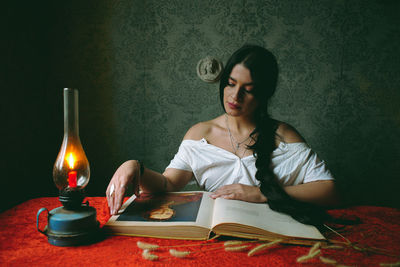 Portrait of woman sitting on table