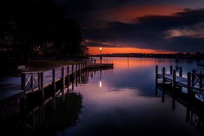 Pier over sea against sky during sunset