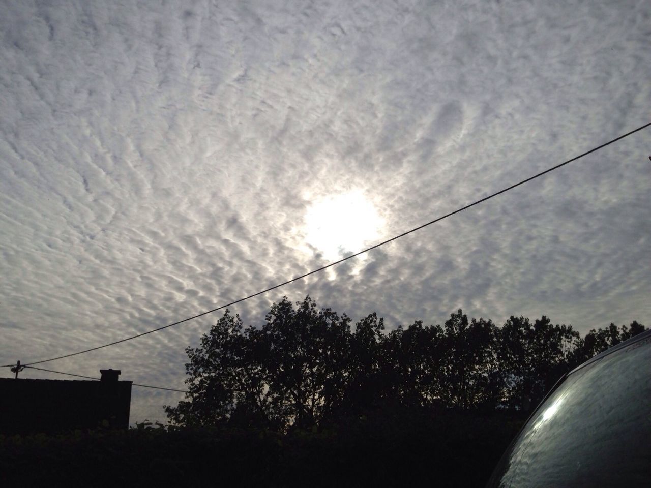 sky, tree, power line, low angle view, silhouette, cloud - sky, sun, electricity, connection, electricity pylon, street light, cable, nature, built structure, sunset, power supply, sunlight, beauty in nature, tranquility, no people