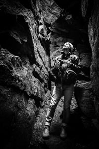 Low angle view of man standing in cave