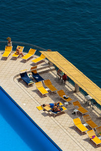 High angle view of people relaxing on pier over sea