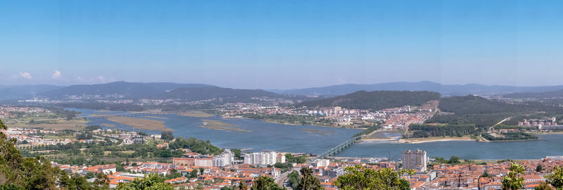 High angle view of townscape by sea against sky